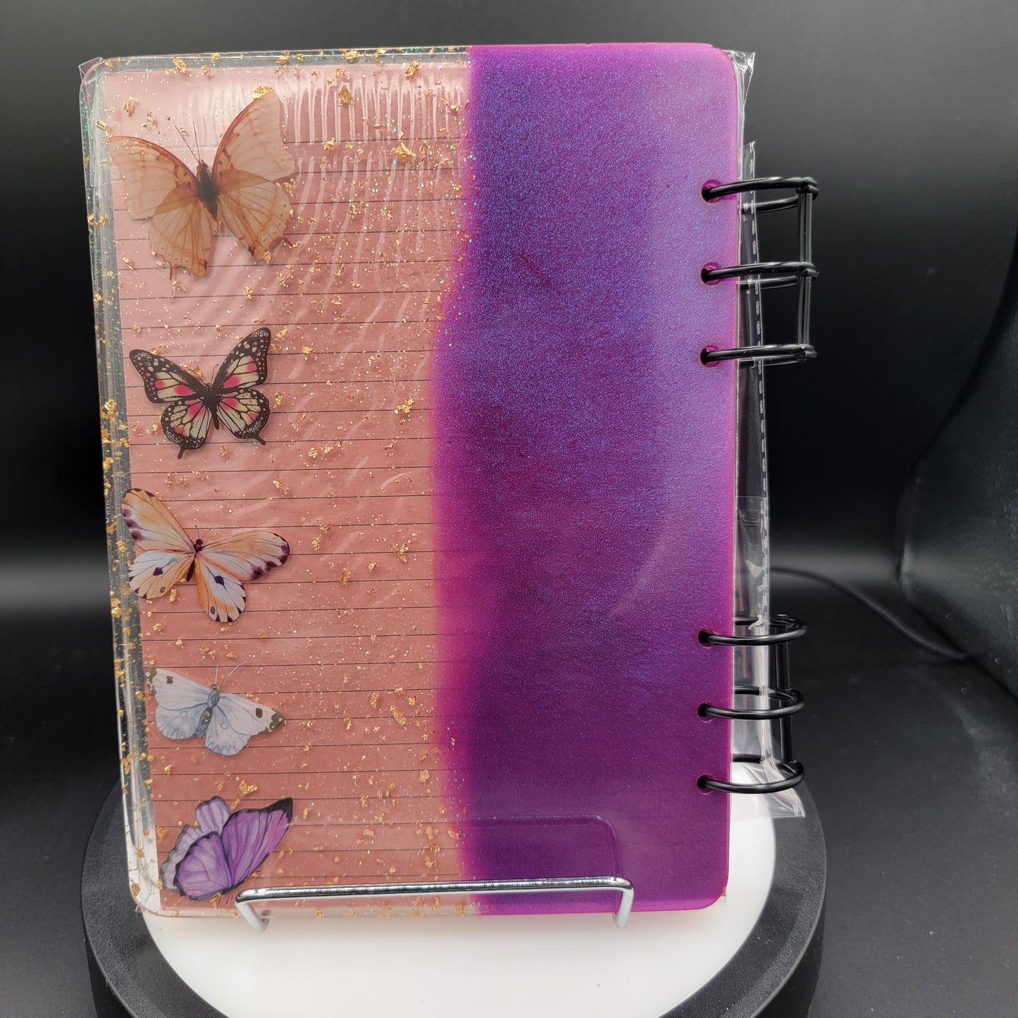 Notebook with butterfly designs on a pink and purple gradient cover