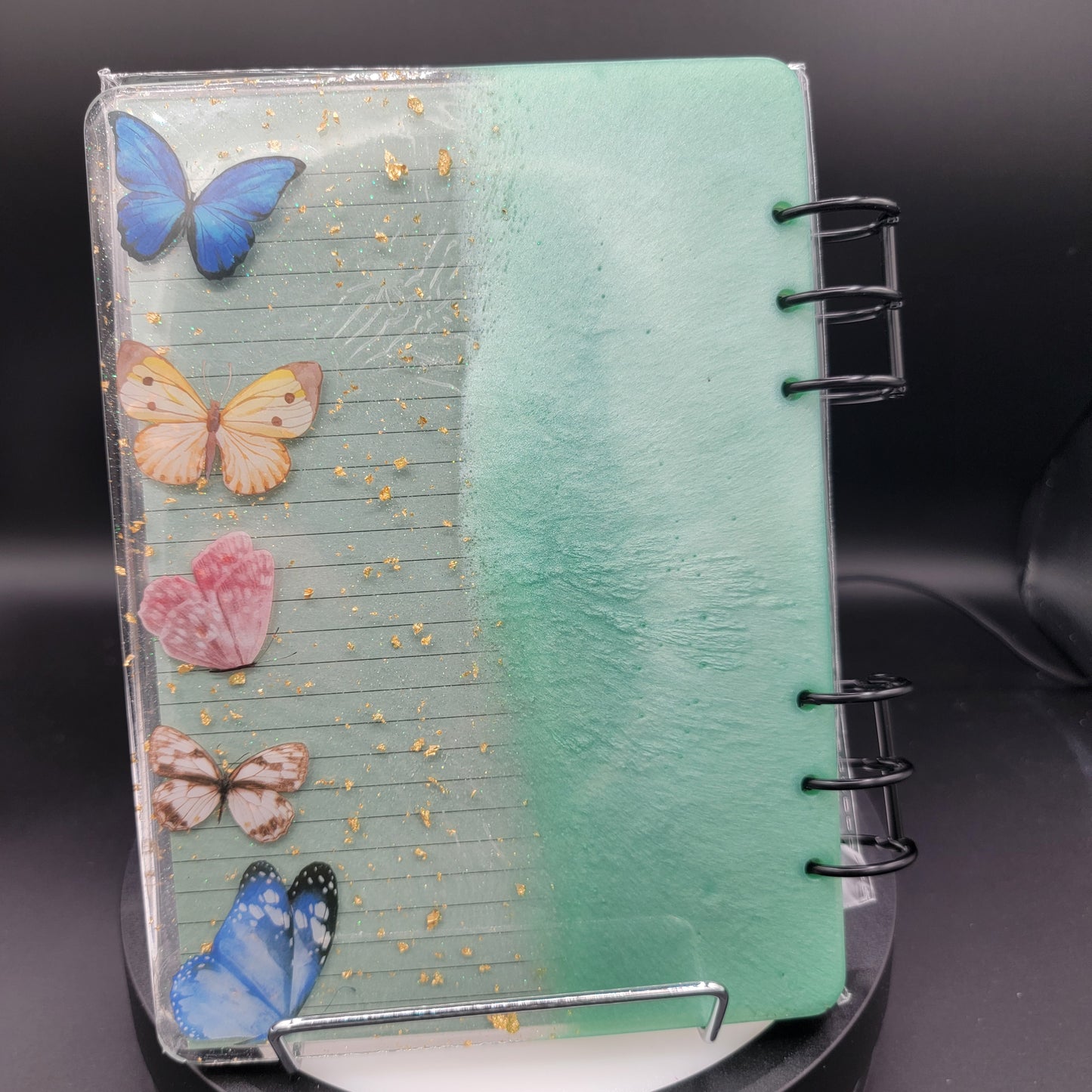 Notebook with butterfly designs on a dark background