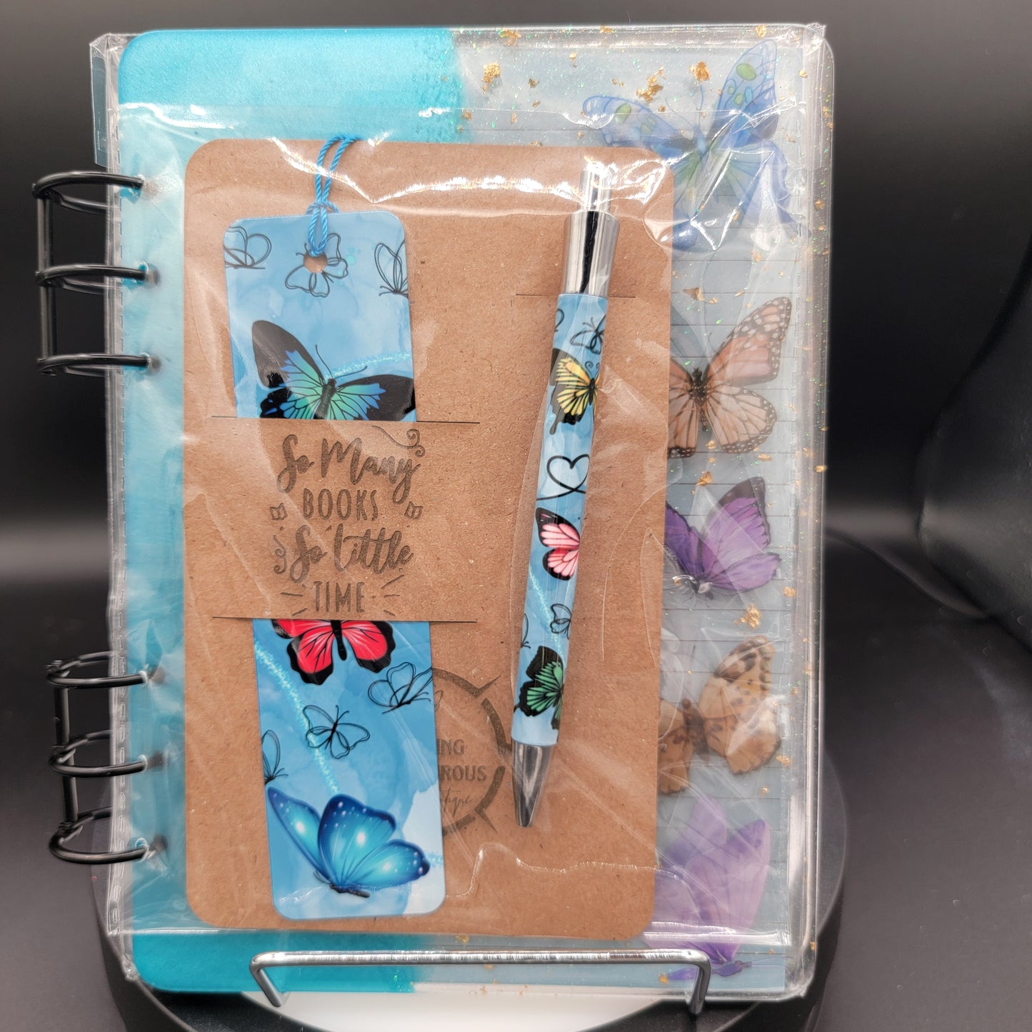 Notebook with butterfly design on cover and clear plastic wrap