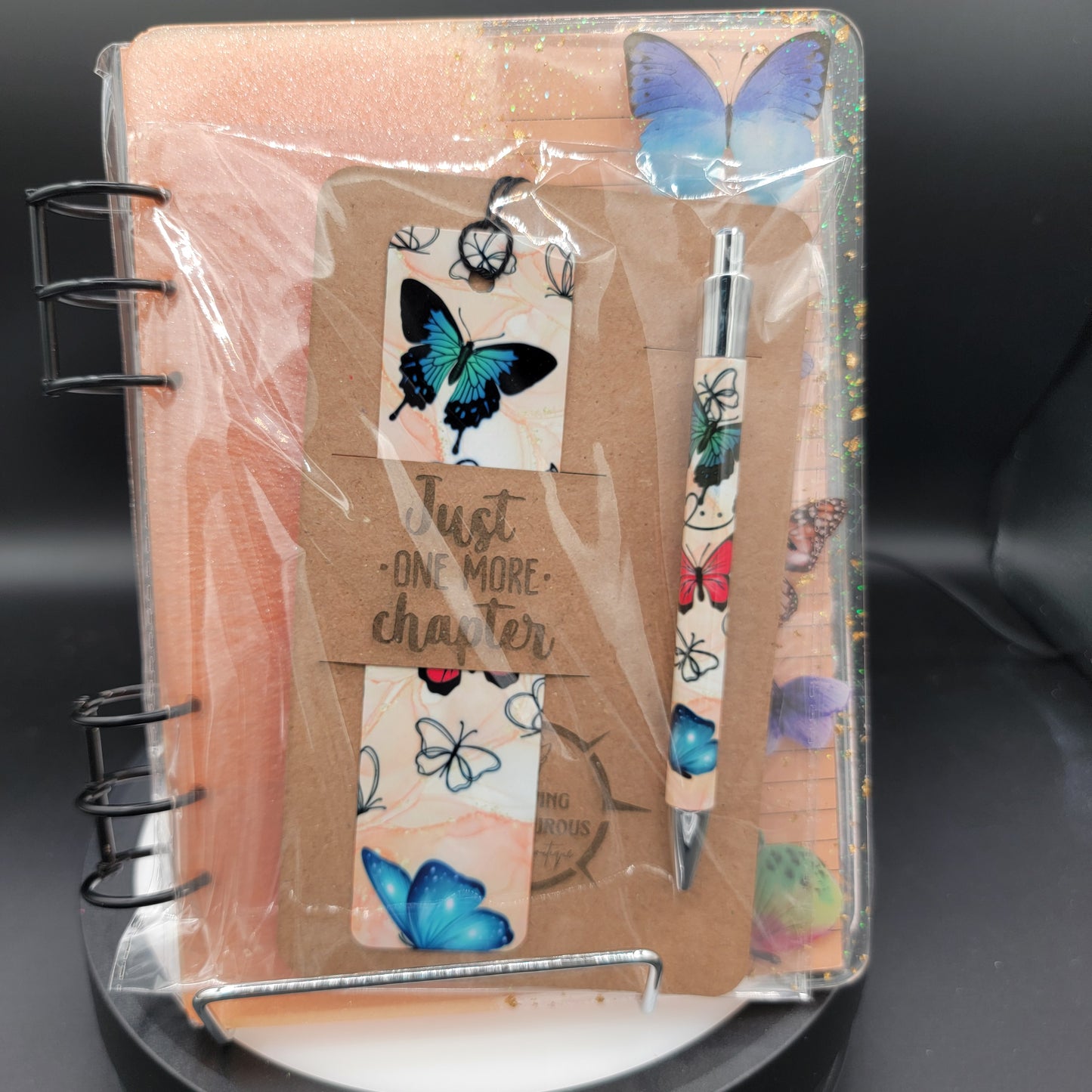 Notebook with pen and butterfly-themed bookmarks in clear packaging