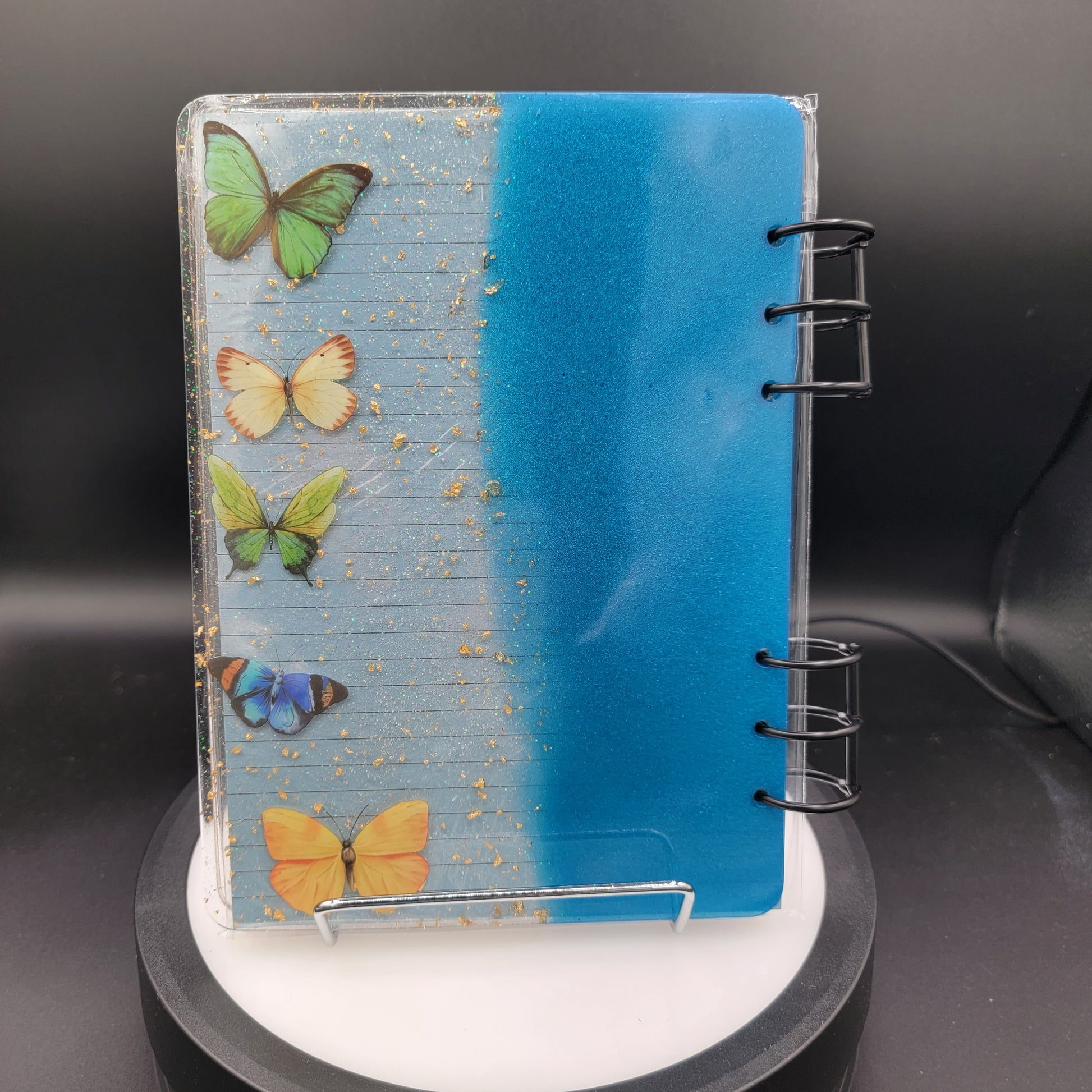 Small notebook with butterfly designs on a dark background