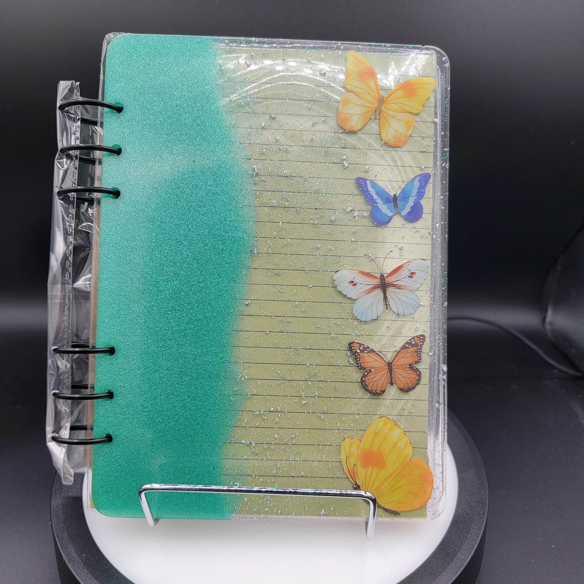 Small notebook with butterfly designs on a dark background