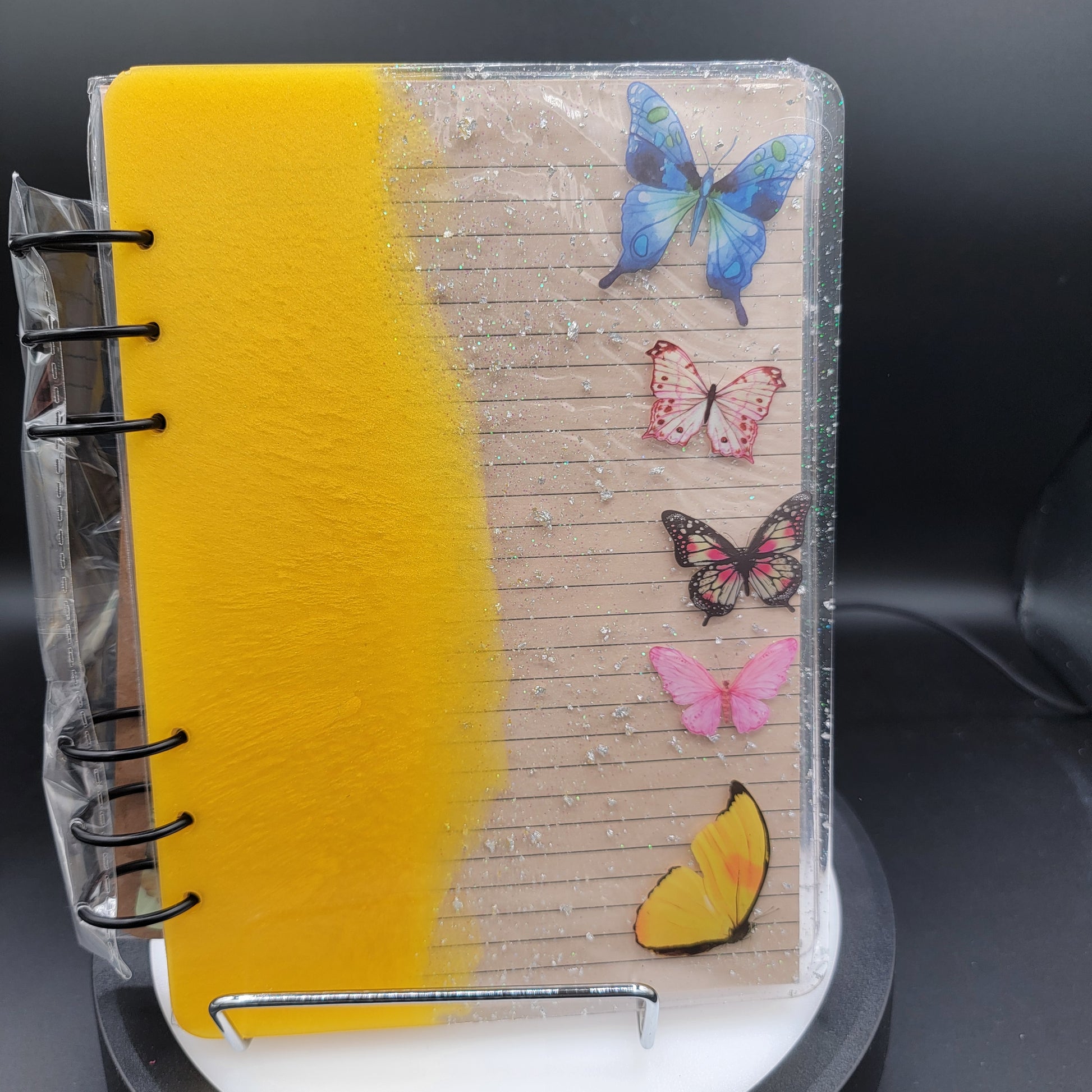 Notebook with butterfly decorations on a dark background