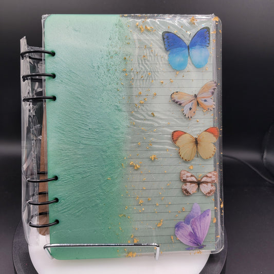Notebook with butterfly decorations on a black background