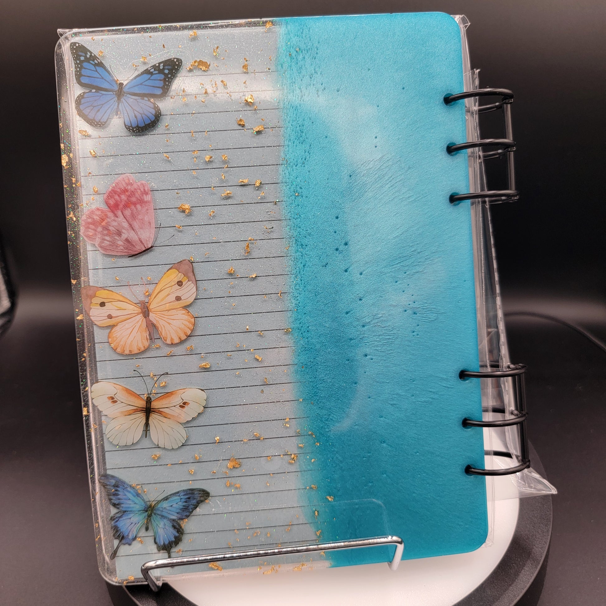 Notebook with butterfly designs on a dark background
