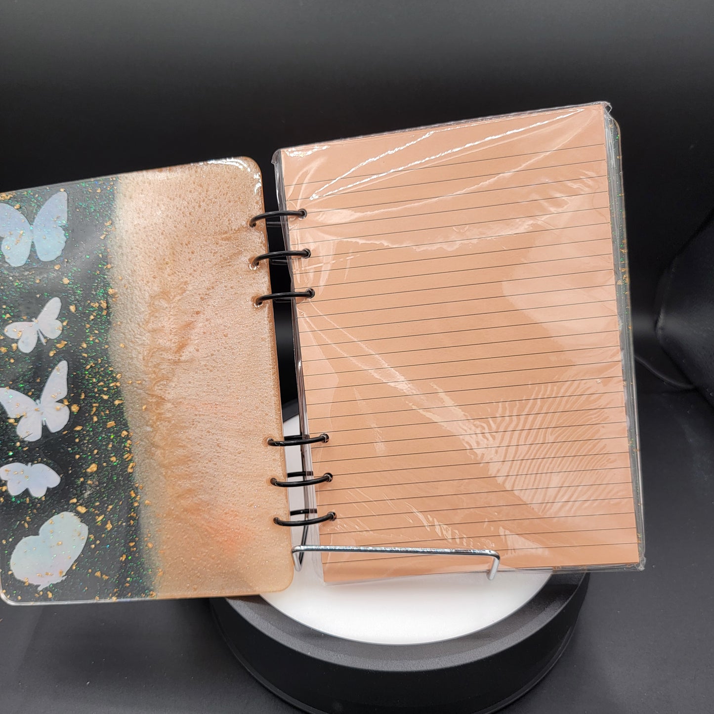 Notebook with wooden cover and floral design on a black background