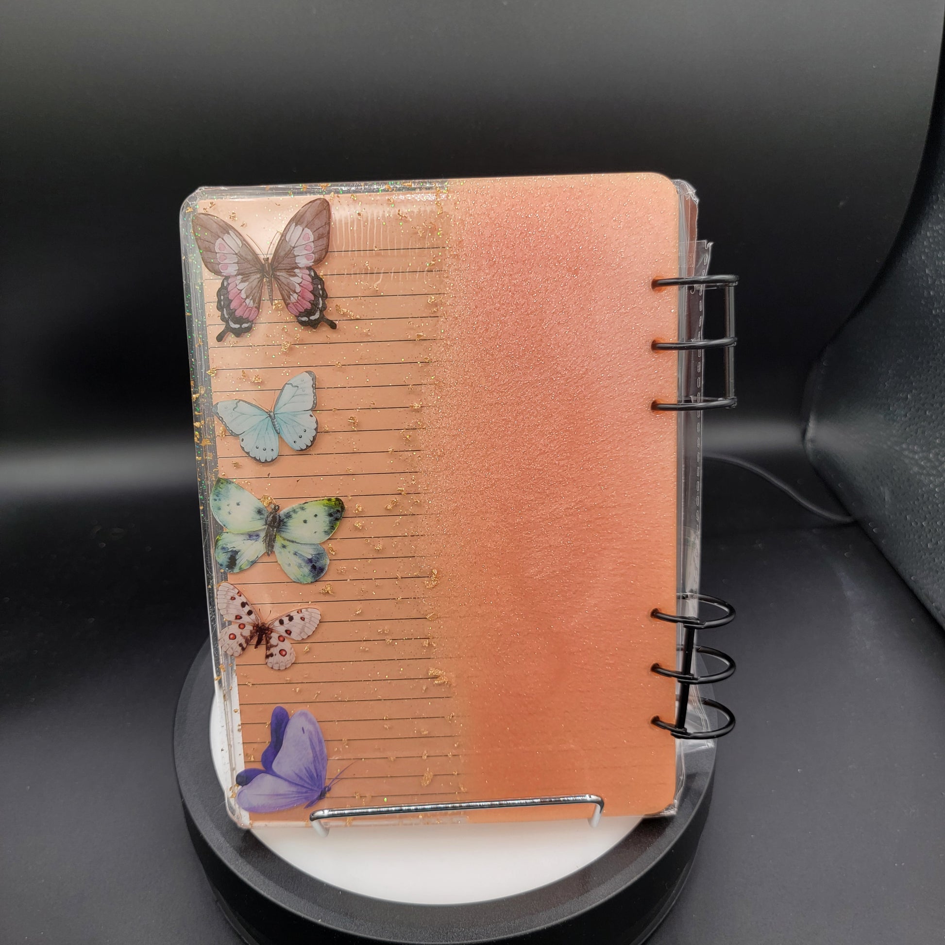 Notebook with butterfly designs on a dark background